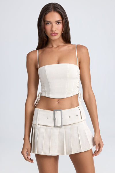 Belted Pleated Low-Rise Micro Mini Skirt in Ecru